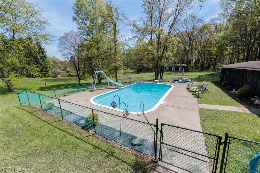 2170 Norton Road Stow, OH 44224 - Photo 3 of 48 Fenced inground swimming pool with a concrete surround and a curved slide