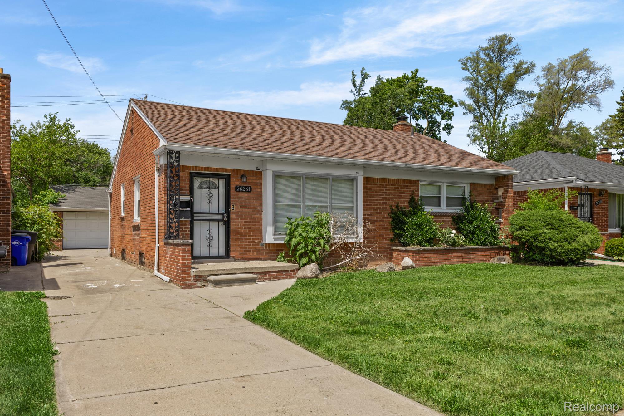 20261 Burt Road Detroit, MI 48219 - Photo 1 of 23 Brick exterior residence featuring a brown shingle roof