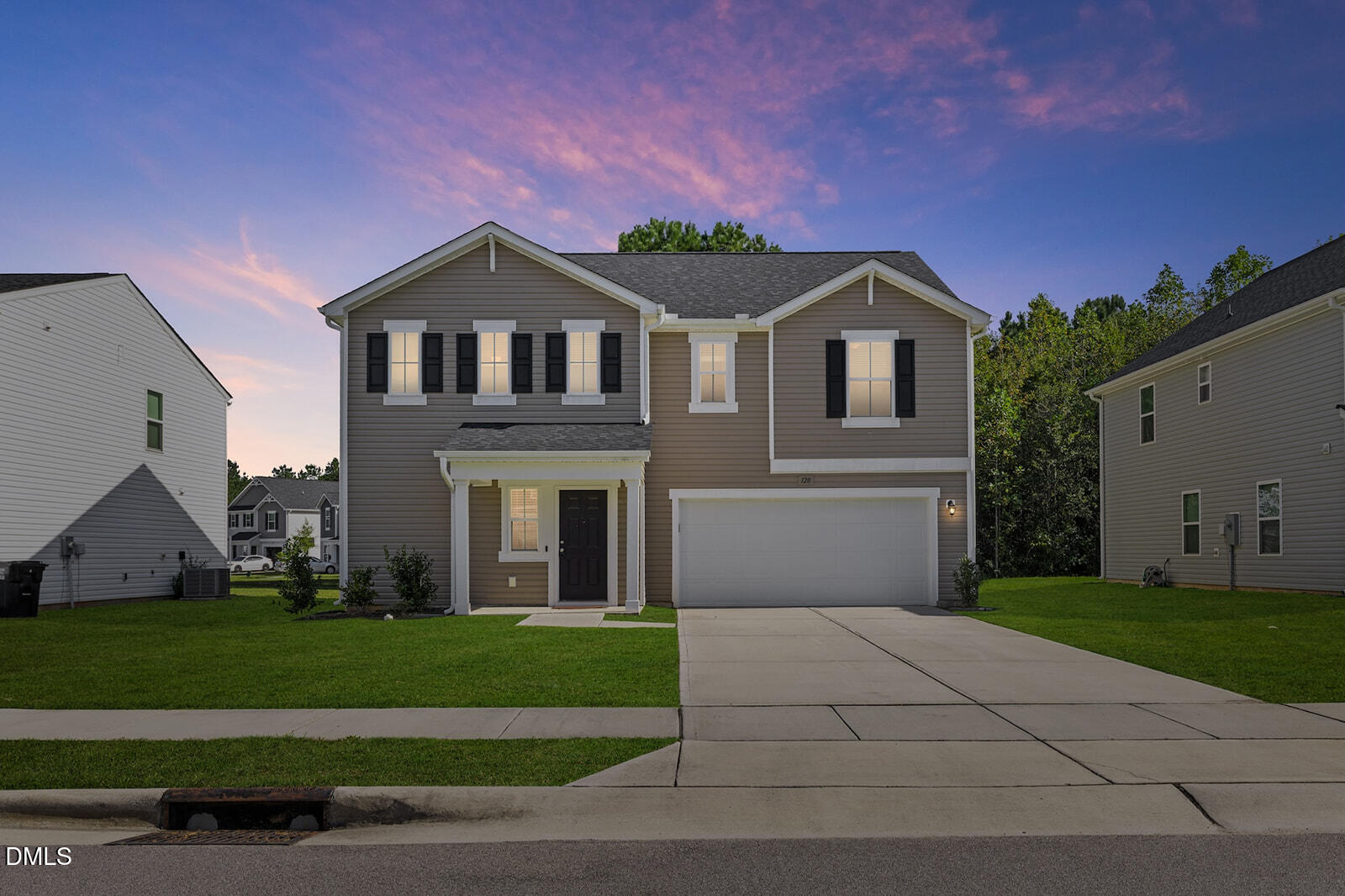 128 Maple Tree Lane Clayton, NC 27527 - Photo 1 of 14 a front view of a house with a yard and garage