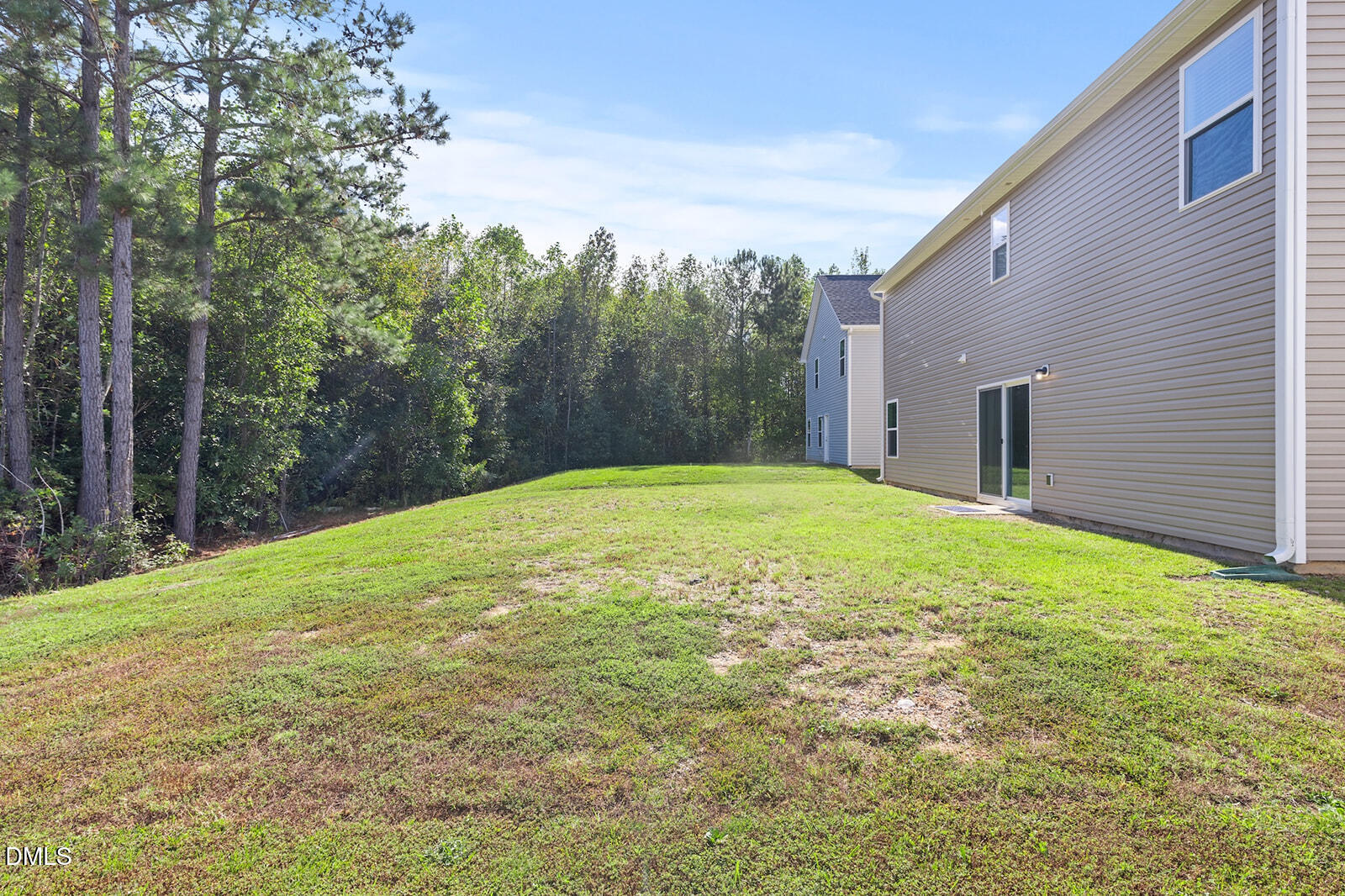 128 Maple Tree Lane Clayton, NC 27527 - Photo 11 of 14 a backyard of a house with lots of green space