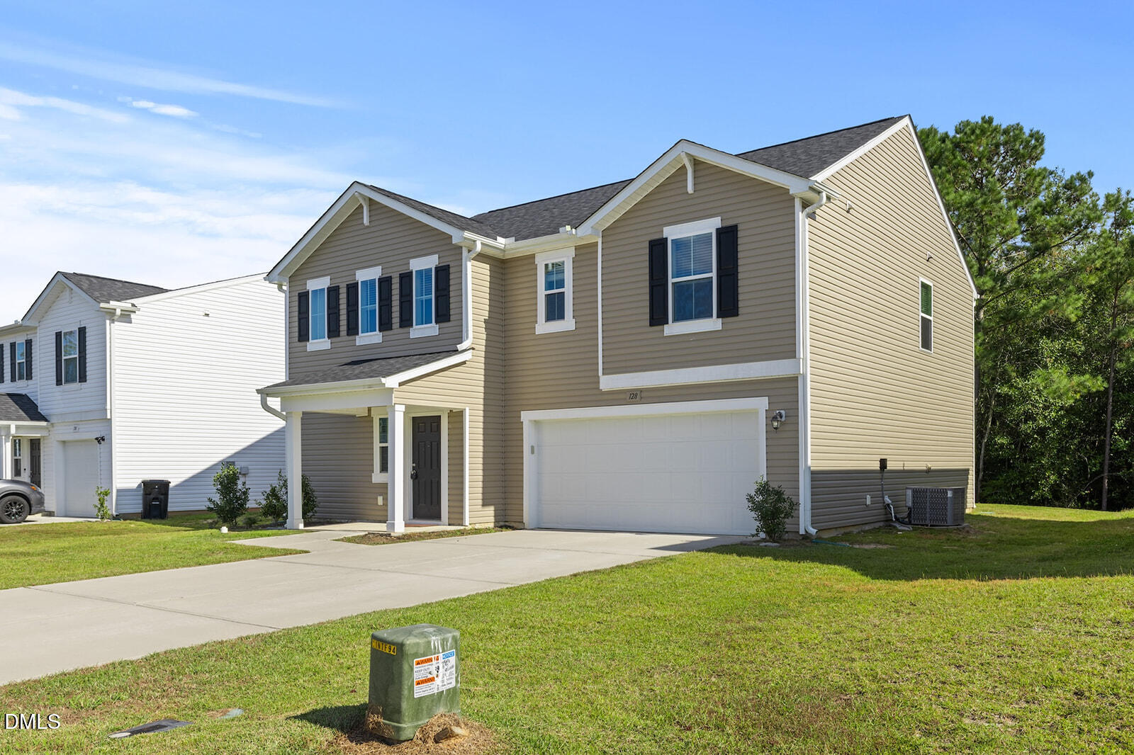 128 Maple Tree Lane Clayton, NC 27527 - Photo 2 of 14 a front view of a house with a yard and garage