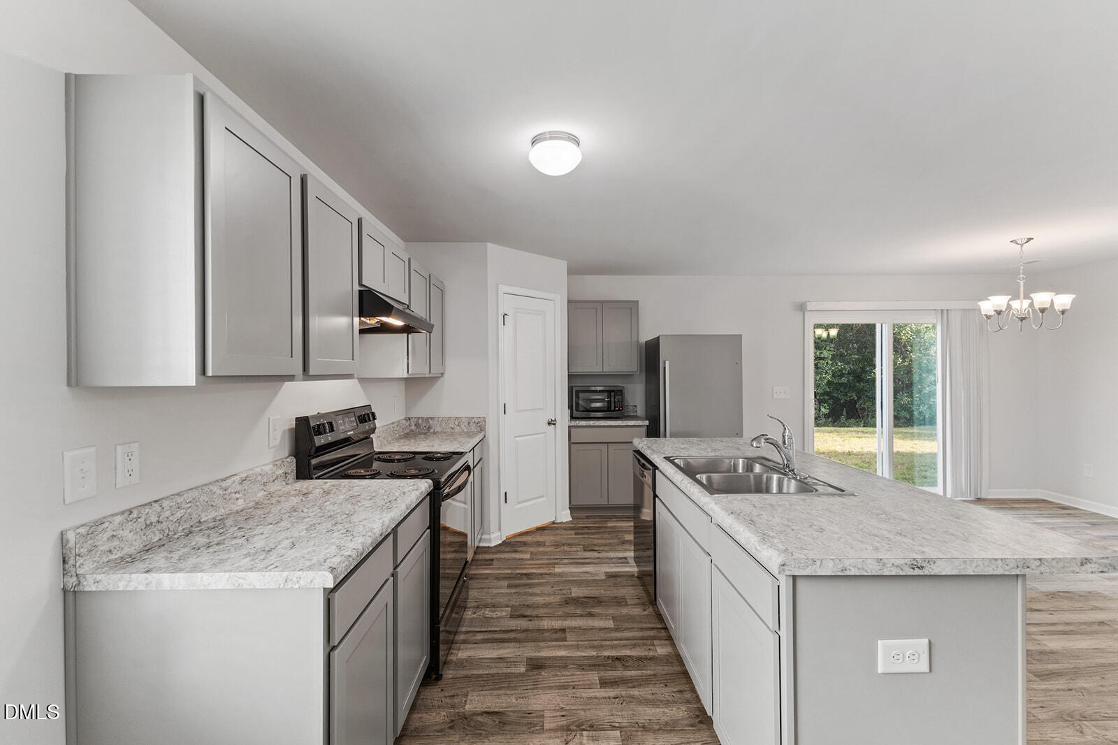 128 Maple Tree Lane Clayton, NC 27527 - Photo 5 of 14 a kitchen with granite countertop kitchen island stainless steel appliances a sink stove and refrigerator
