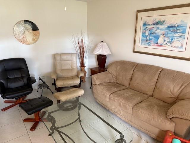 678 Durham, Unit 678 Deerfield Beach, FL 33442 - Photo 1 of 9 a living room with furniture a rug and a chair