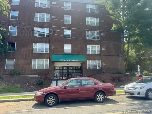 a front view of a house with parking space