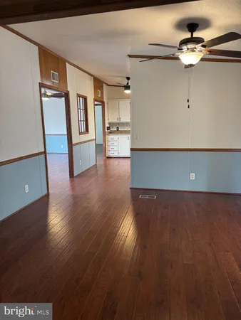 a view of wooden floor and windows in a room
