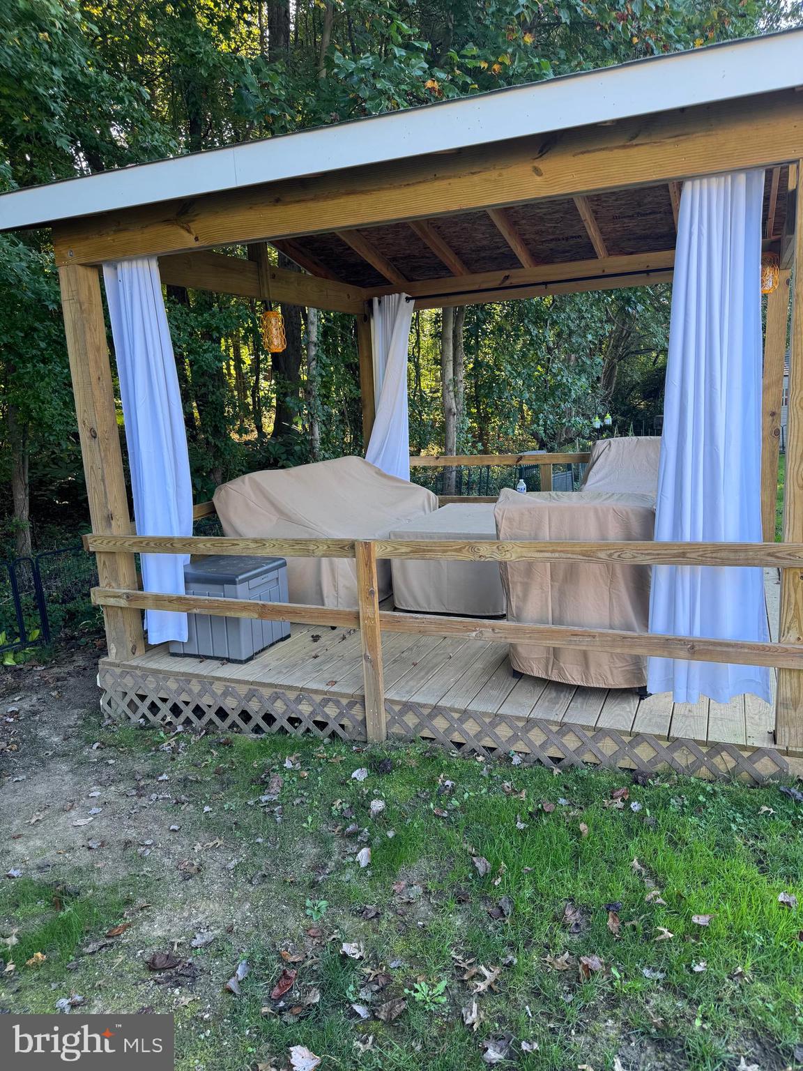 460 Sarah Anne Drive Lothian, MD 20711 - Photo 40 of 62 a view of a backyard with table and chairs potted plants with wooden fence