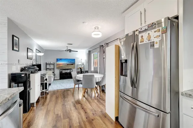 a kitchen with a sink cabinets and wooden floor