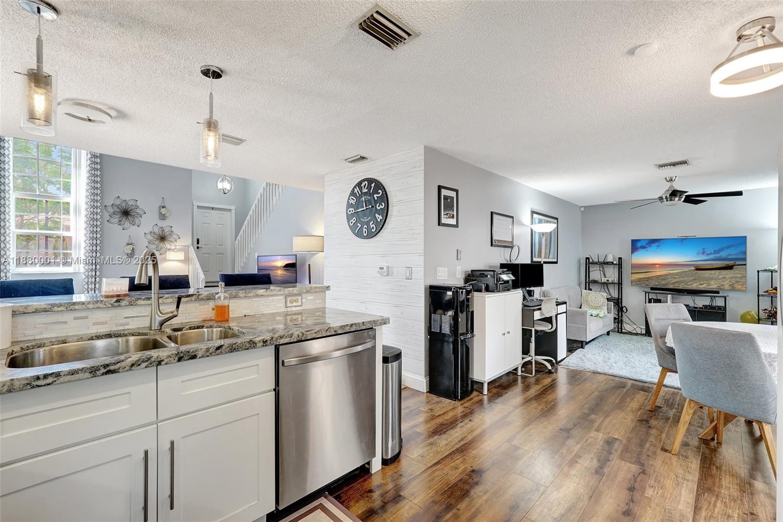 9900 Northwest 2nd Court Plantation, FL 33324 - Photo 13 of 56 a kitchen with a sink cabinets and wooden floor