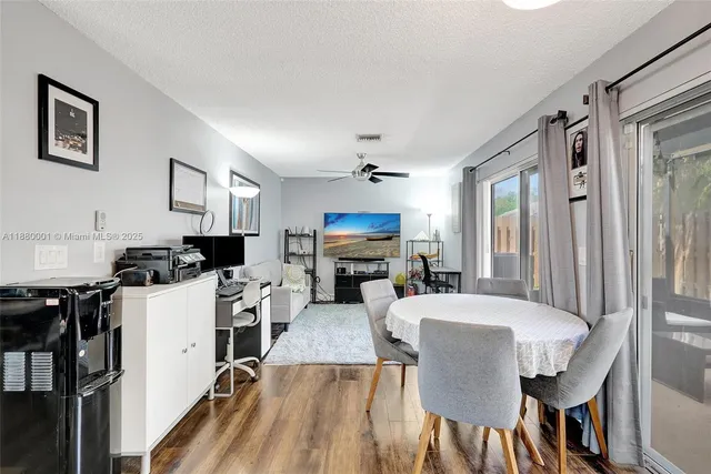 a living room with stainless steel appliances kitchen island granite countertop furniture and a kitchen view
