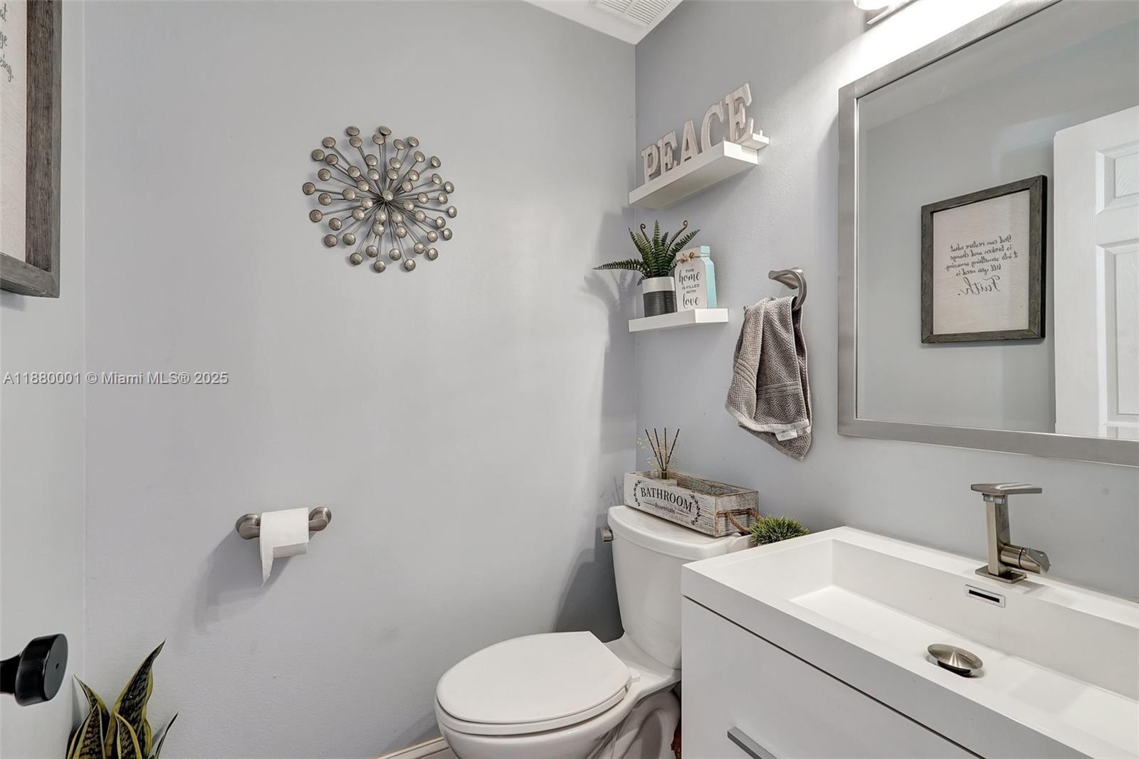 9900 Northwest 2nd Court Plantation, FL 33324 - Photo 17 of 56 a bathroom with a toilet sink and mirror