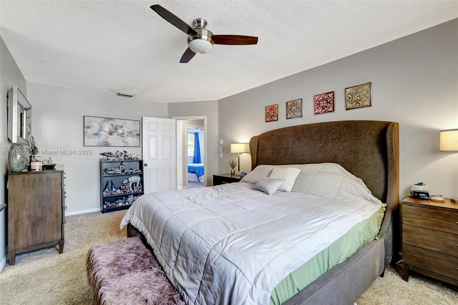 9900 Northwest 2nd Court Plantation, FL 33324 - Photo 22 of 56 a bedroom with a large bed and a walk in closet