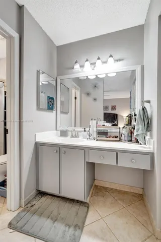 a bathroom with a shower and a plant on the wall
