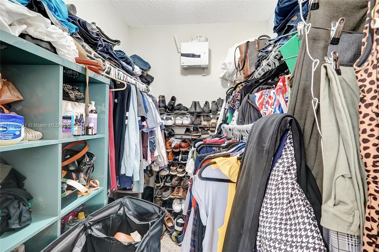 9900 Northwest 2nd Court Plantation, FL 33324 - Photo 28 of 56 a view of walk in closet with clothes and shoes