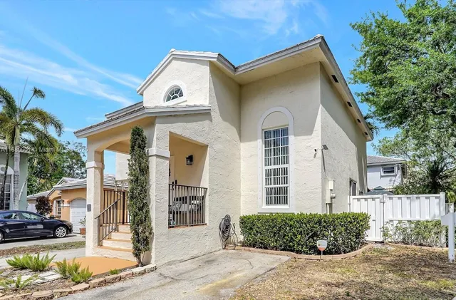 a front view of a house with a garden