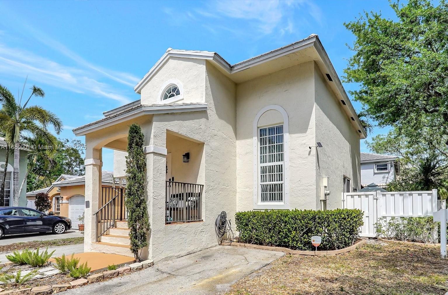 9900 Northwest 2nd Court Plantation, FL 33324 - Photo 3 of 56 a front view of a house with a garden