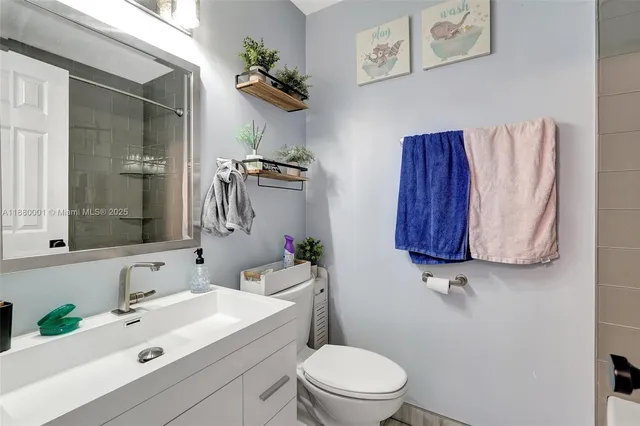 a bathroom with a toilet sink and mirror