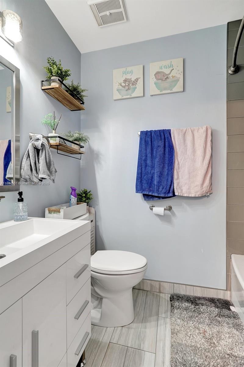 9900 Northwest 2nd Court Plantation, FL 33324 - Photo 32 of 56 a bathroom with a toilet sink and mirror