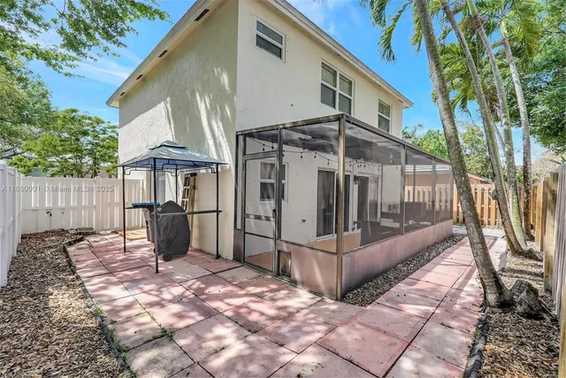 a view of a house with backyard and sitting area