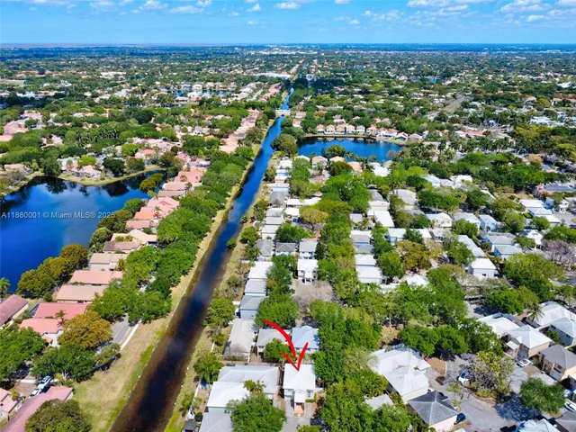 an aerial view of lake and residential houses with outdoor space