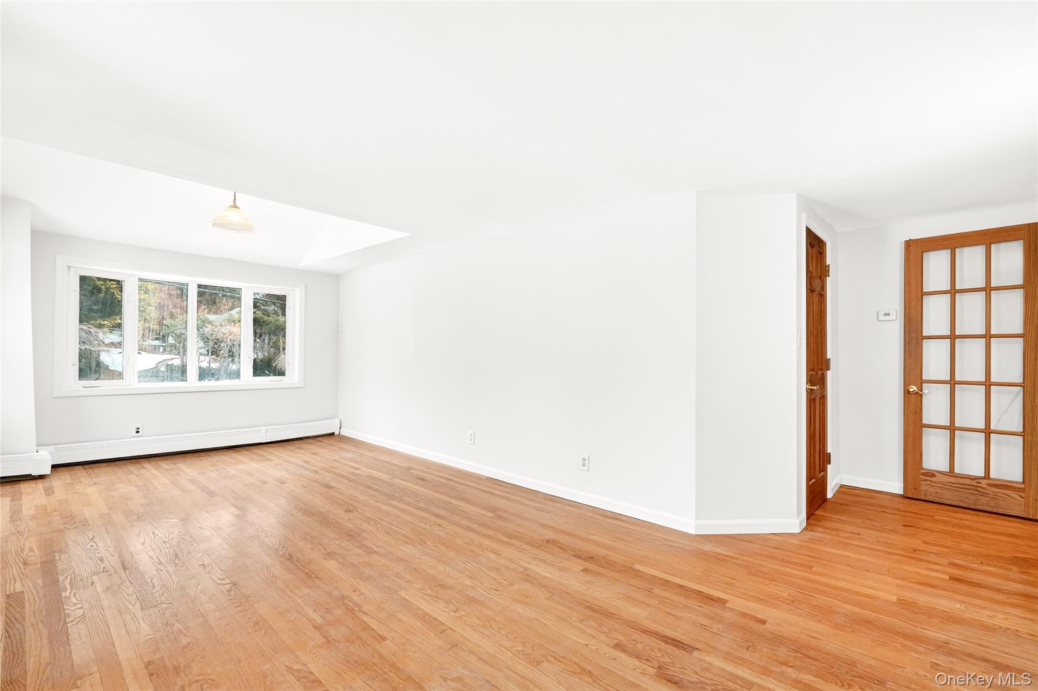 24 Old Knollwood Road White Plains, NY 10607 - Photo 11 of 49 a view of an empty room with window and wooden floor