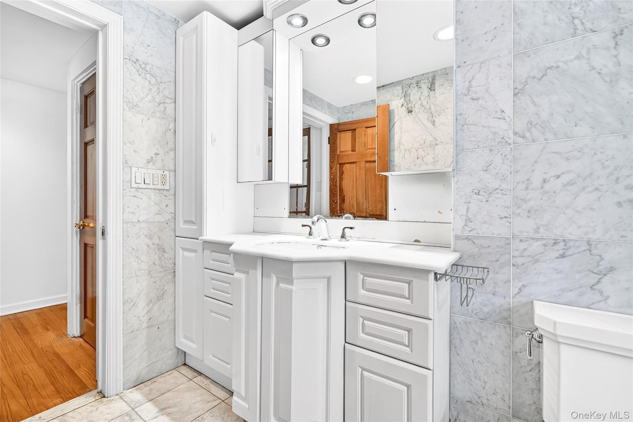 24 Old Knollwood Road White Plains, NY 10607 - Photo 15 of 49 a bathroom with a sink vanity granite and a mirror
