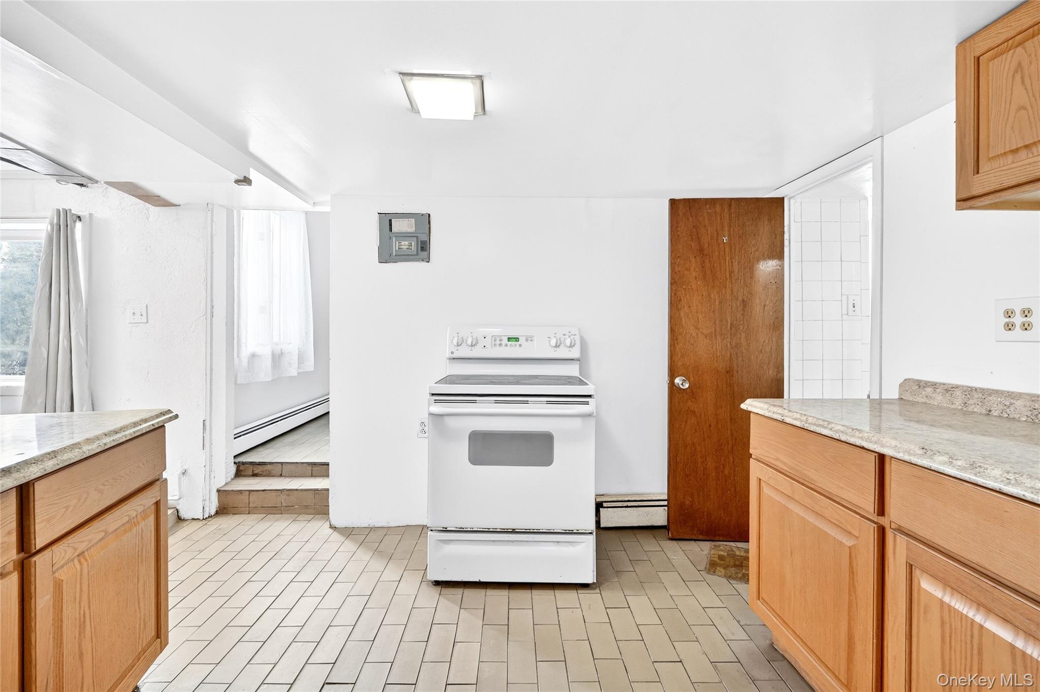 24 Old Knollwood Road White Plains, NY 10607 - Photo 33 of 49 a kitchen with a stove and a refrigerator