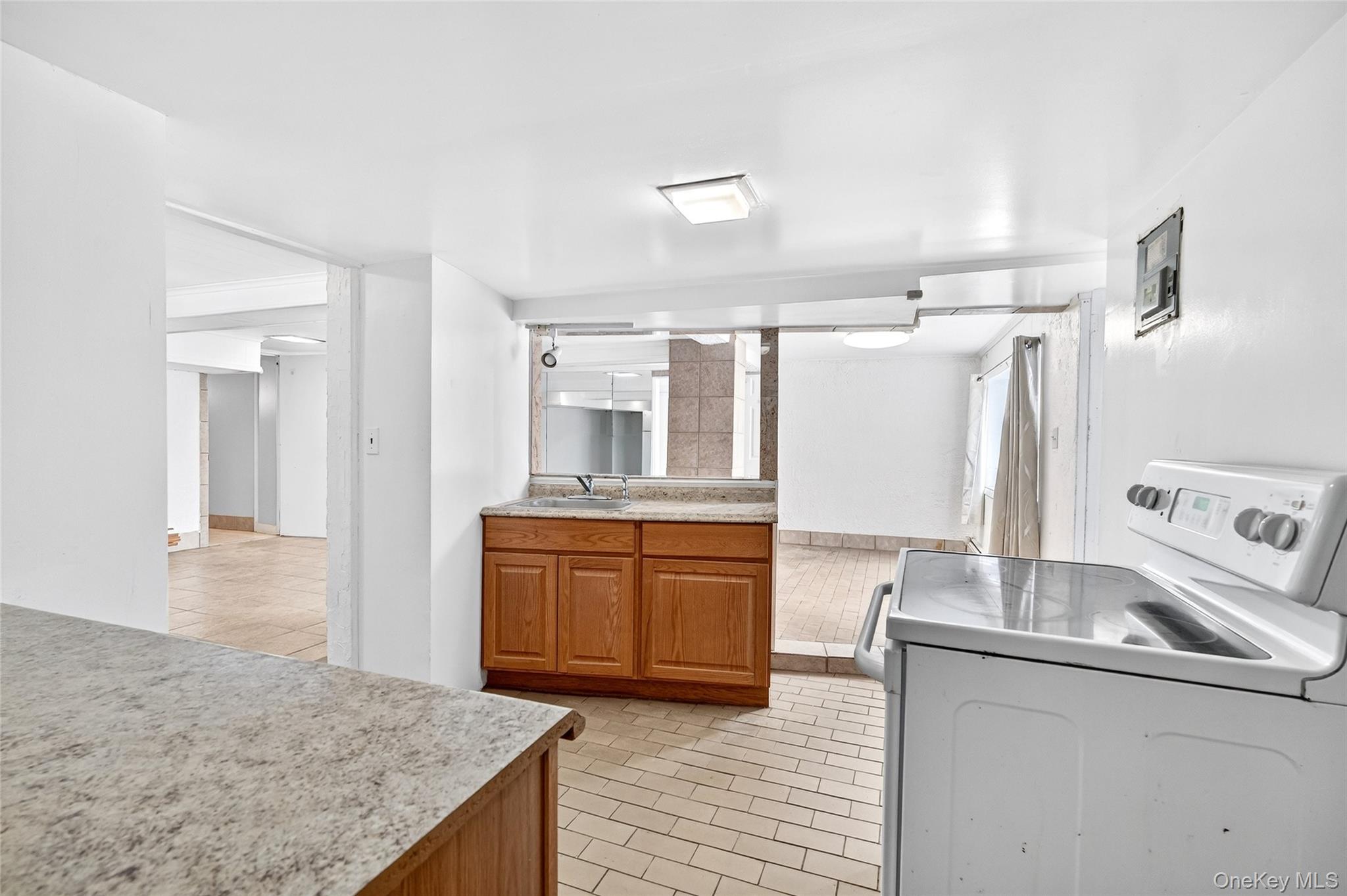 24 Old Knollwood Road White Plains, NY 10607 - Photo 34 of 49 a kitchen with stainless steel appliances granite countertop a sink refrigerator and cabinets