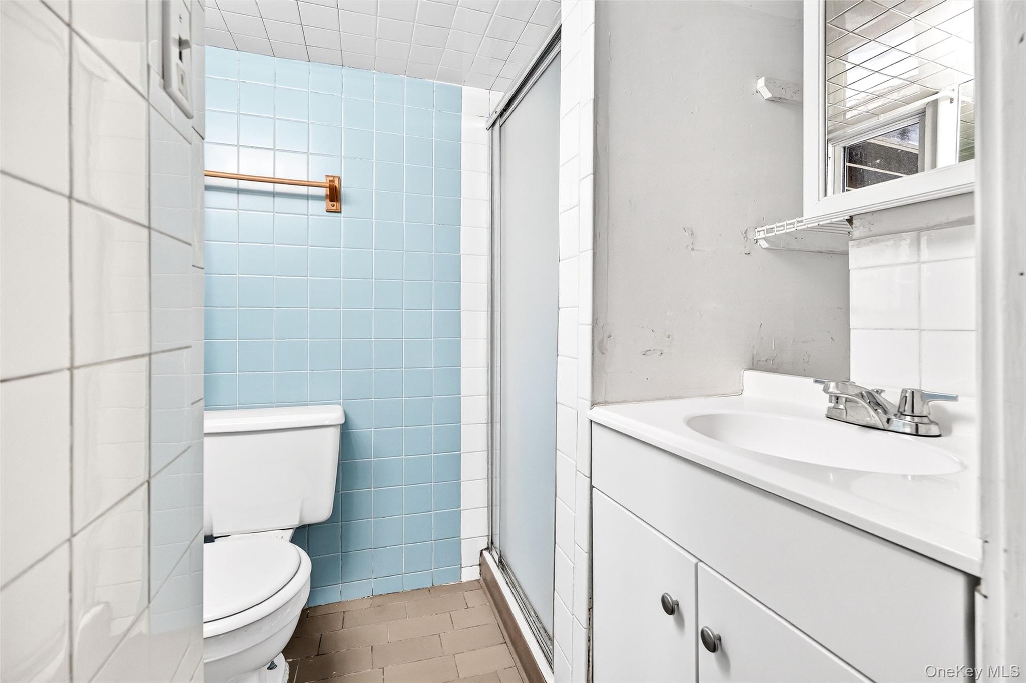 24 Old Knollwood Road White Plains, NY 10607 - Photo 35 of 49 a bathroom with a sink a toilet a mirror and shower
