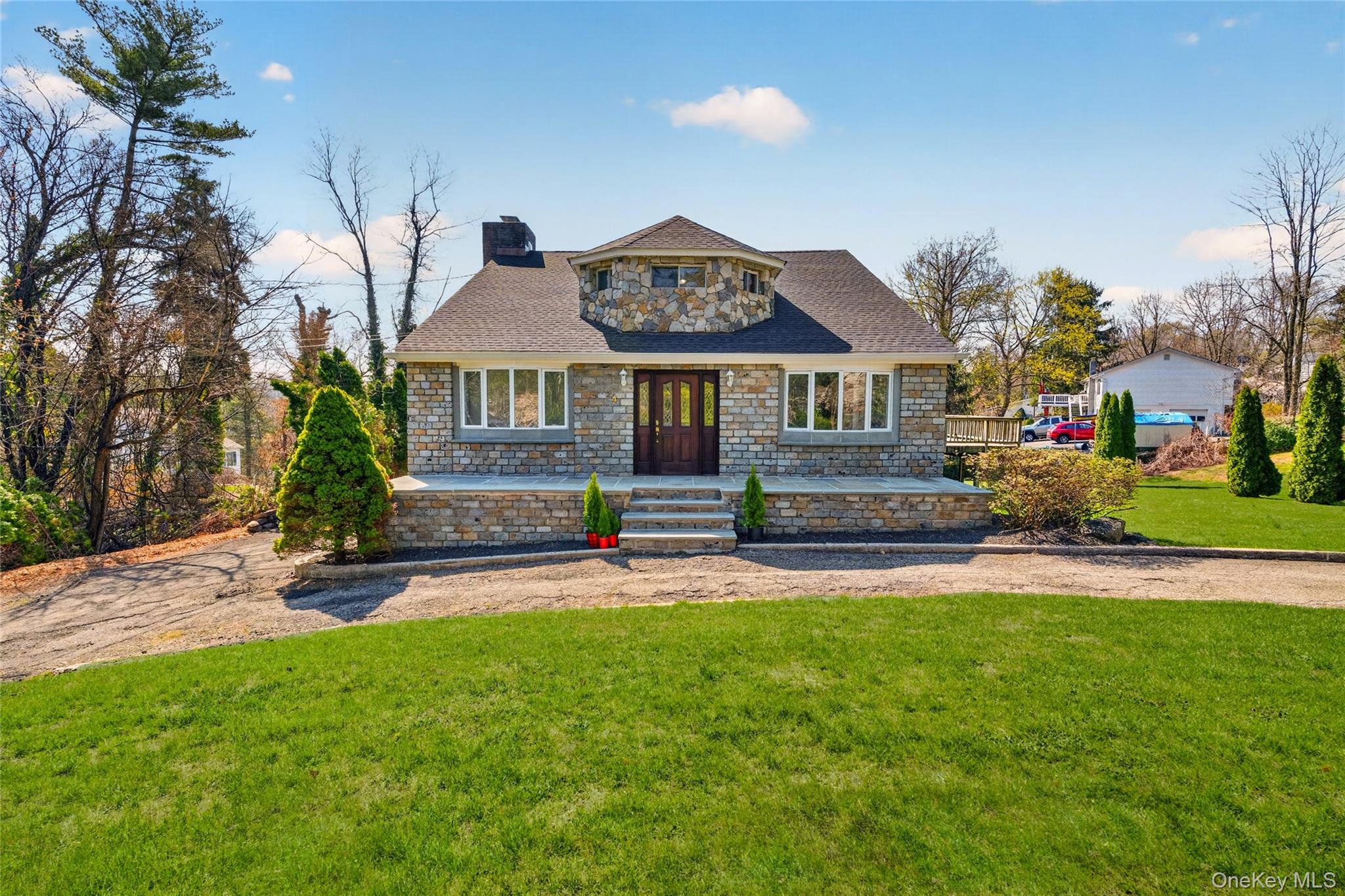 24 Old Knollwood Road White Plains, NY 10607 - Photo 47 of 49 a front view of a house with a garden and yard