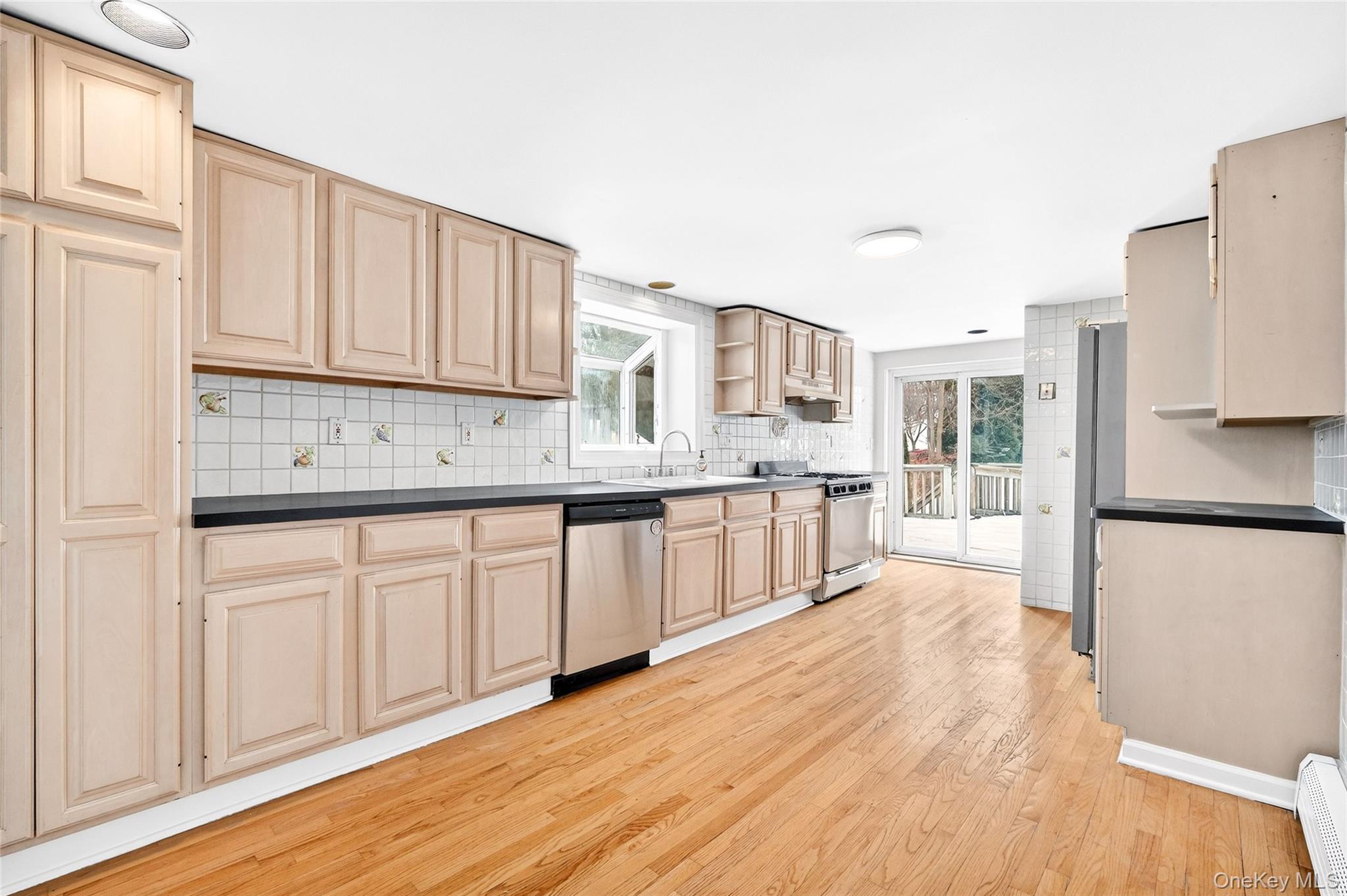 24 Old Knollwood Road White Plains, NY 10607 - Photo 6 of 49 a kitchen with stainless steel appliances granite countertop a refrigerator sink and white cabinets