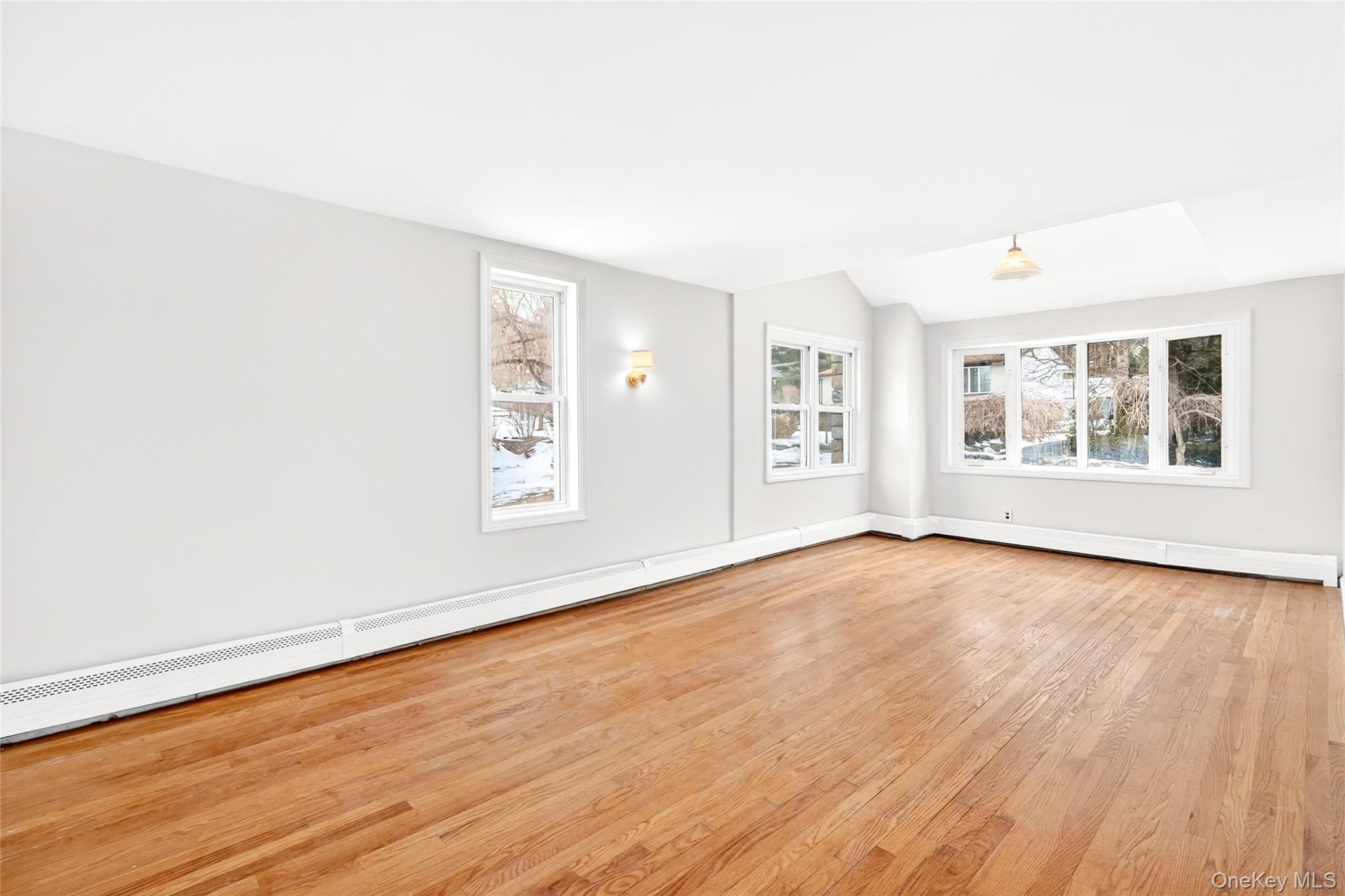 24 Old Knollwood Road White Plains, NY 10607 - Photo 9 of 49 an empty room with wooden floor and windows