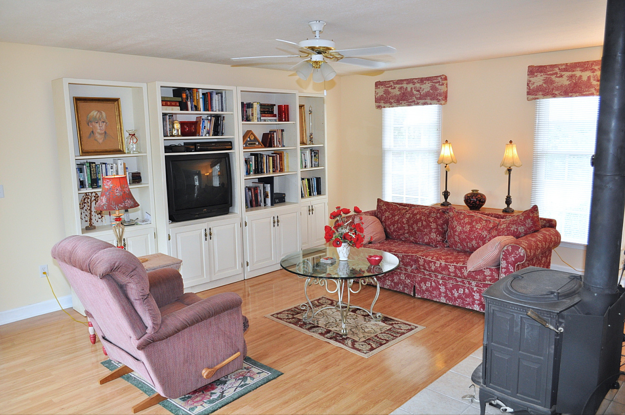 1167 Factory Hill Road Callaway, VA 24067 - Photo 30 of 80 a living room with furniture a flat screen tv and a table