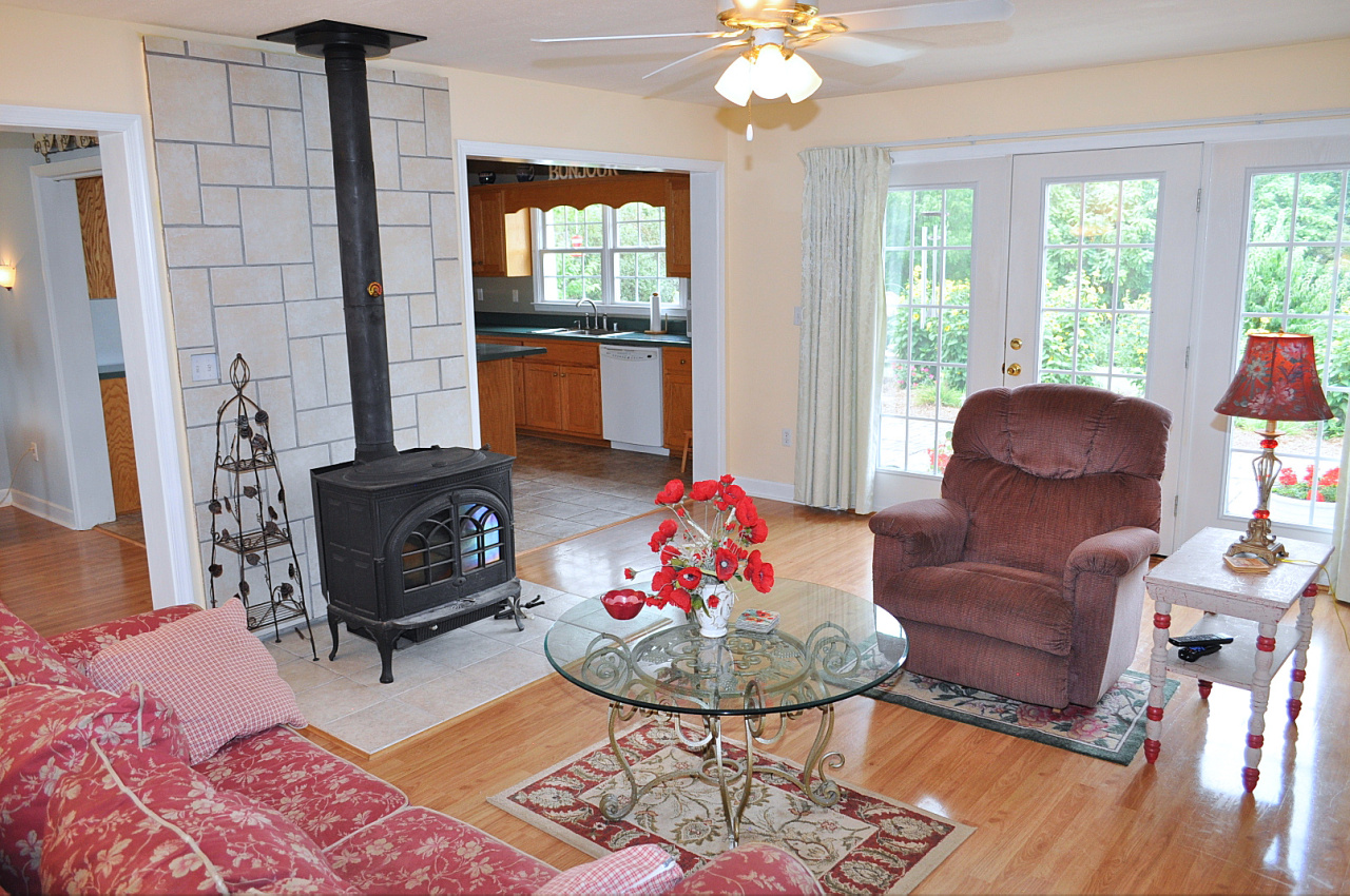 1167 Factory Hill Road Callaway, VA 24067 - Photo 33 of 80 a living room with furniture a fireplace and a chandelier