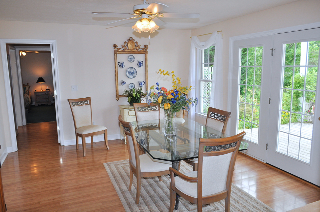 1167 Factory Hill Road Callaway, VA 24067 - Photo 39 of 80 a dining room with furniture potted plants and wooden floor