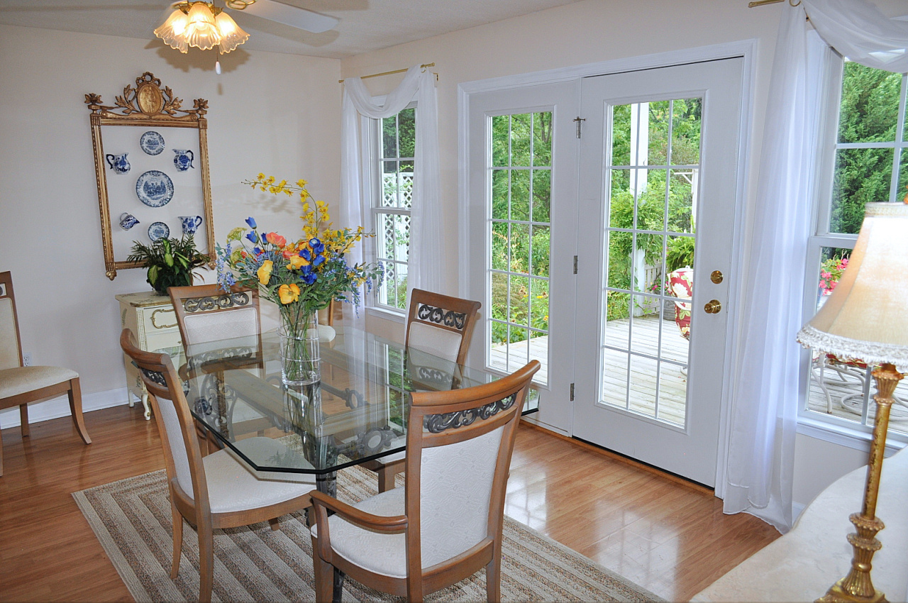 1167 Factory Hill Road Callaway, VA 24067 - Photo 43 of 80 a dining room with furniture and wooden floor a chandelier