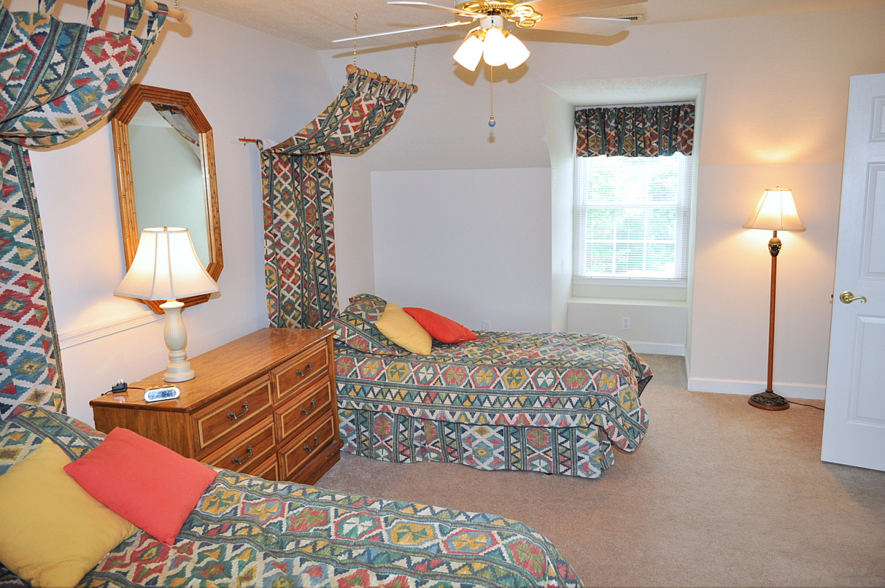 1167 Factory Hill Road Callaway, VA 24067 - Photo 58 of 80 a bedroom with a bed and a chandelier