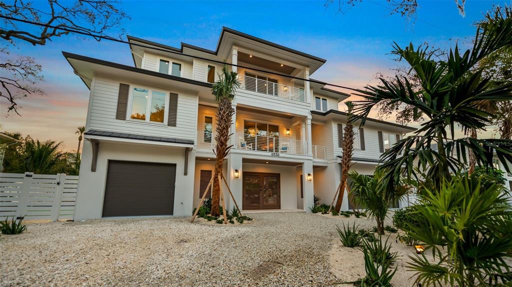 6536 Peacock Road Sarasota, FL 34242 - Photo 1 of 82 a front view of a house with a yard