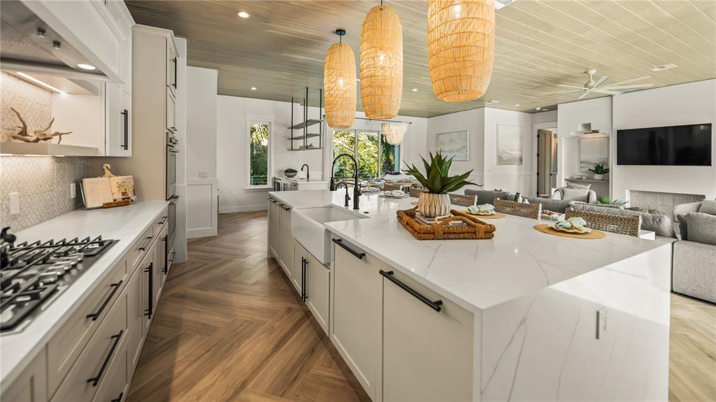6536 Peacock Road Sarasota, FL 34242 - Photo 19 of 82 a kitchen with sink stove and cabinets