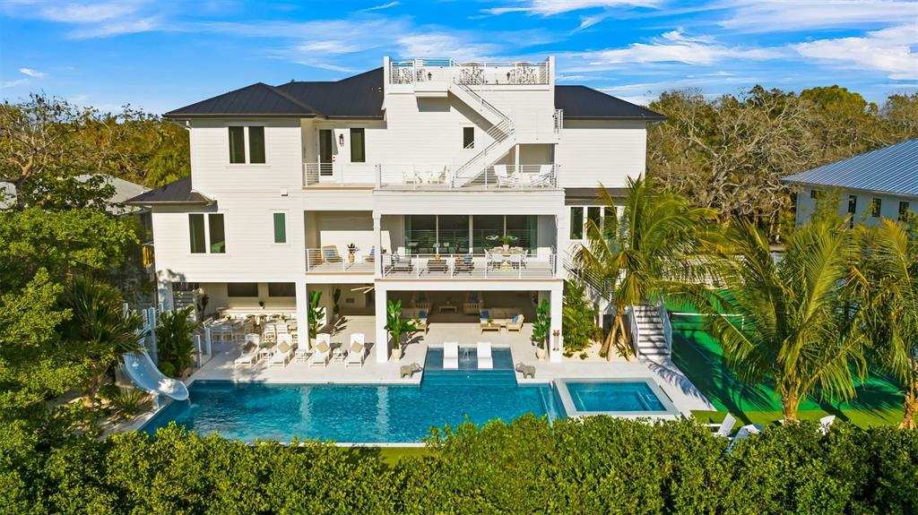 6536 Peacock Road Sarasota, FL 34242 - Photo 2 of 82 a front view of a house with garden