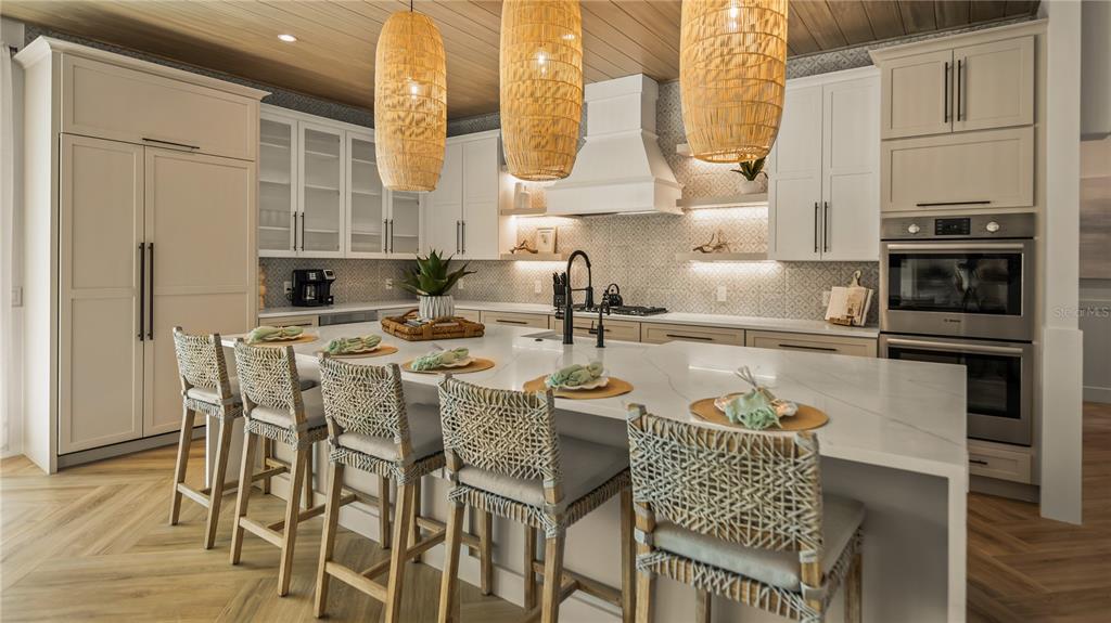 6536 Peacock Road Sarasota, FL 34242 - Photo 21 of 82 a kitchen with granite countertop kitchen island stainless steel appliances a sink table and chairs