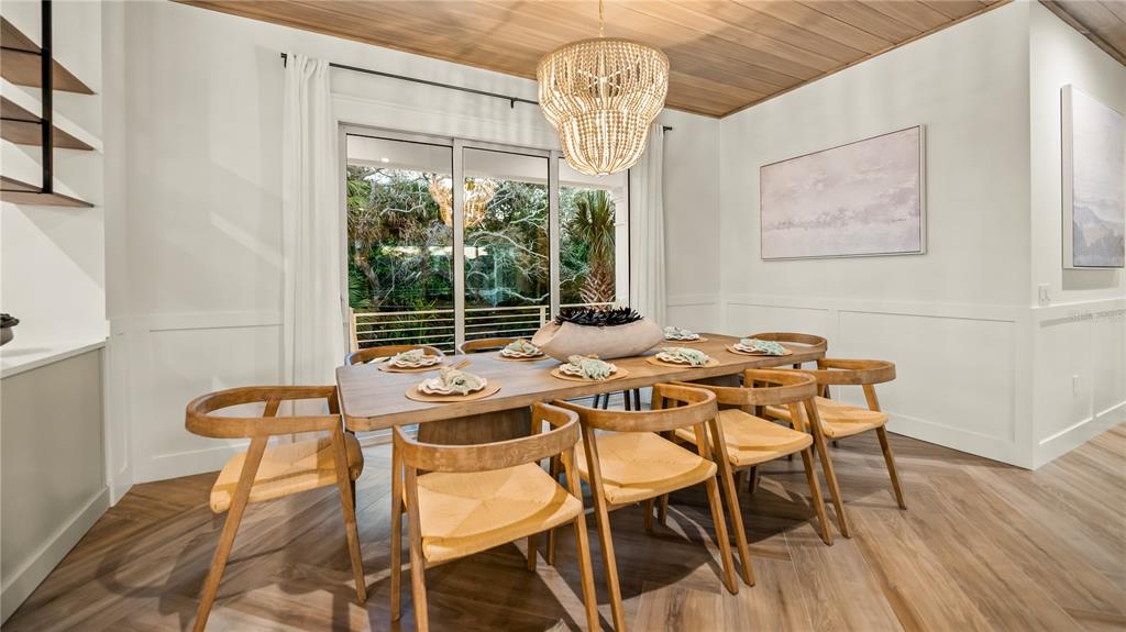 6536 Peacock Road Sarasota, FL 34242 - Photo 22 of 82 a view of a dining room with furniture wooden floor and chandelier