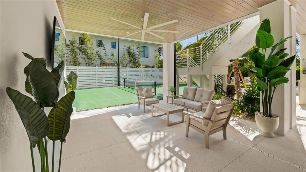 6536 Peacock Road Sarasota, FL 34242 - Photo 32 of 82 a view of a patio with table and chairs and potted plants
