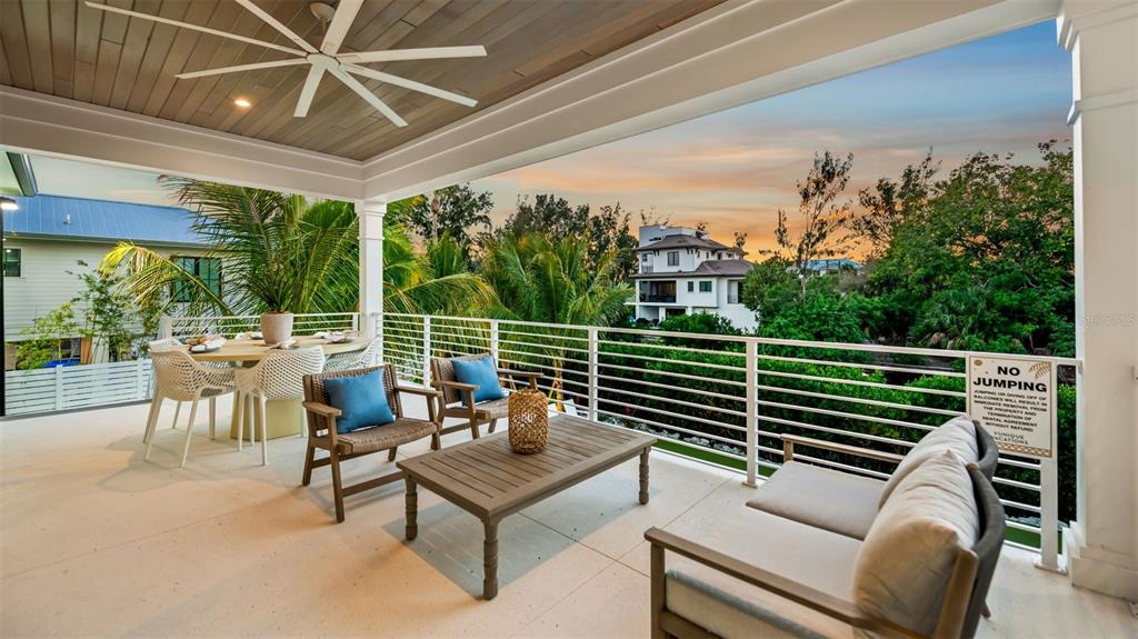 6536 Peacock Road Sarasota, FL 34242 - Photo 38 of 82 a view of a chairs and tables in the back yard of the house