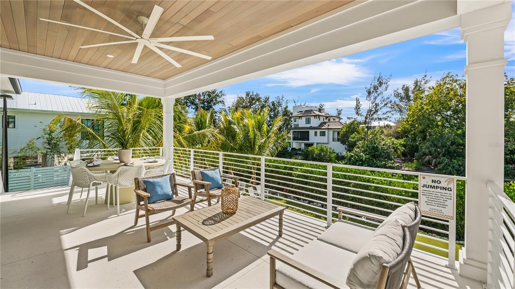 6536 Peacock Road Sarasota, FL 34242 - Photo 40 of 82 a view of a balcony with chairs and a table