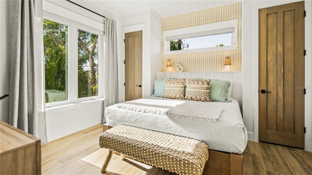 6536 Peacock Road Sarasota, FL 34242 - Photo 43 of 82 a bedroom with a bed and wooden floor