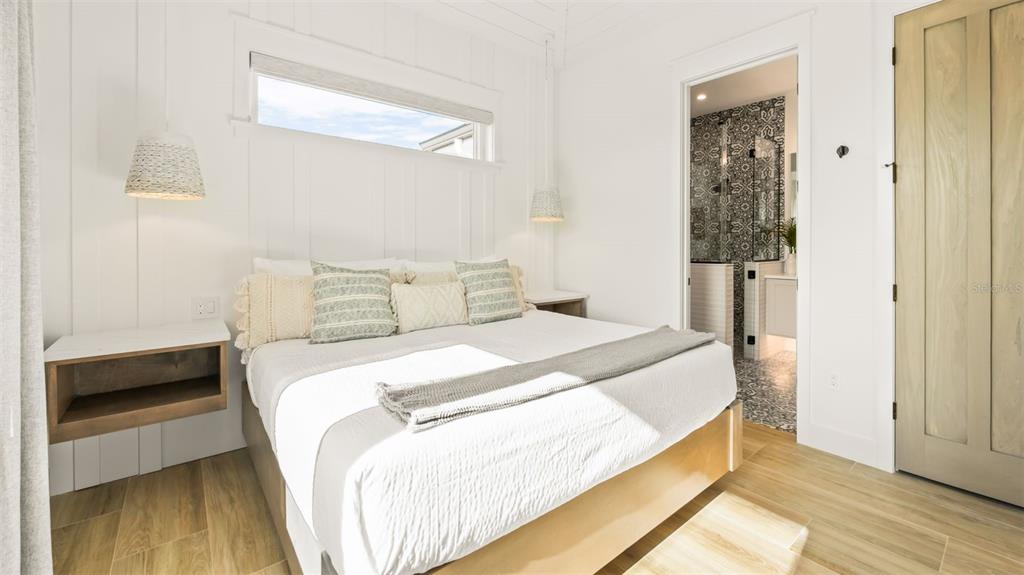 6536 Peacock Road Sarasota, FL 34242 - Photo 45 of 82 a bedroom with a bed and a walk in closet