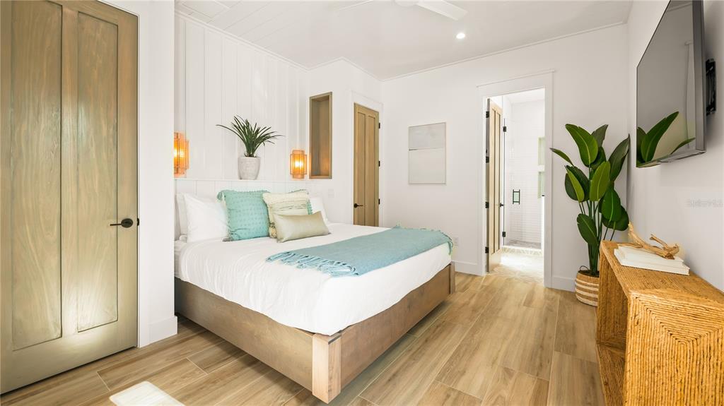 6536 Peacock Road Sarasota, FL 34242 - Photo 46 of 82 a spacious bedroom with a bed and a potted plant