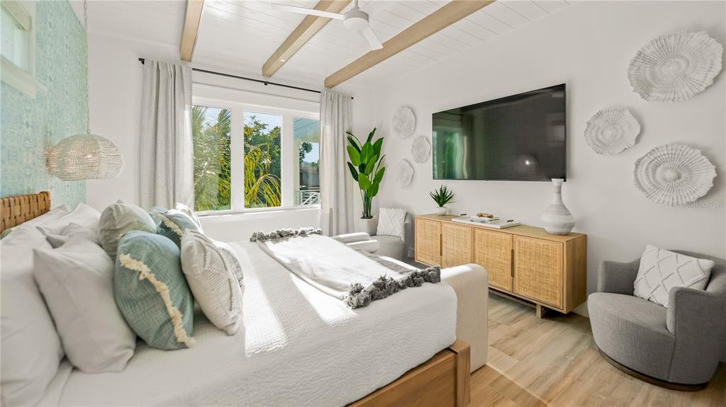 6536 Peacock Road Sarasota, FL 34242 - Photo 48 of 82 a living room with furniture and a flat screen tv