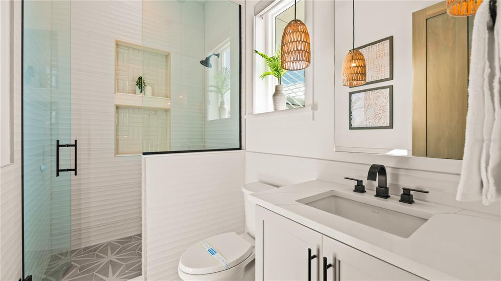 6536 Peacock Road Sarasota, FL 34242 - Photo 58 of 82 a bathroom with a sink a toilet and a mirror