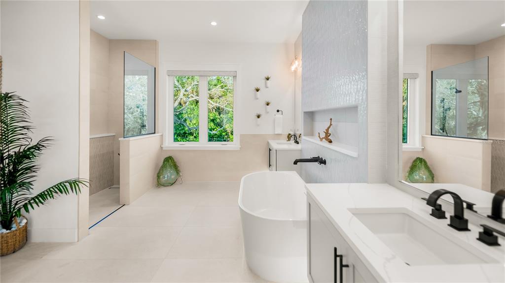 6536 Peacock Road Sarasota, FL 34242 - Photo 60 of 82 a bathroom with a granite countertop sink and a bathtub